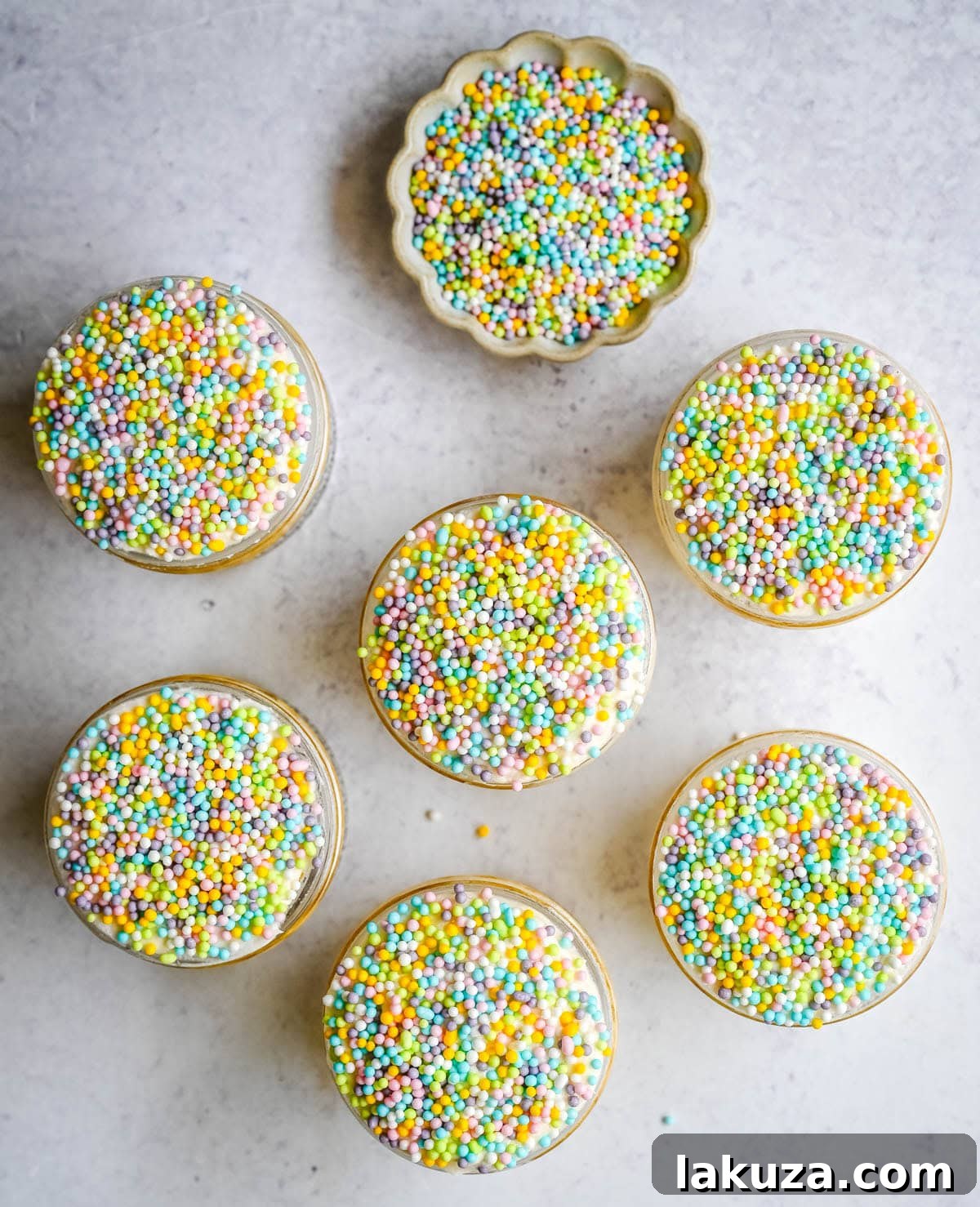 Jarred Dot Cake Recipe: Layered Mini Cakes in a Jar 7 This viral dot cake recipe brings the NYC sprinkle cake trend straight to your kitchen — no trip to Butterfield Market required! Soft, buttery homemade yellow cake layered in a cup, topped with creamy vanilla buttercream, and completely coated in rainbow nonpareil sprinkles for that irresistible crunch. This easy homemade version is better than any boxed mix recipe you'll find — and takes less than an hour to make!