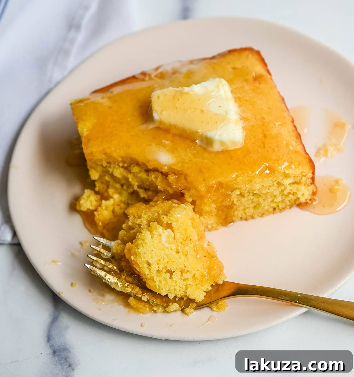 This moist and fluffy hot honey cornbread is sweet, slightly spicy, and absolutely packed with flavor from the very first bite!  This is the most irresistible cornbread topped with hot honey butter you will ever make, and it comes together in just one bowl in under 30 minutes, making it the easiest and most flavorful side dish.
