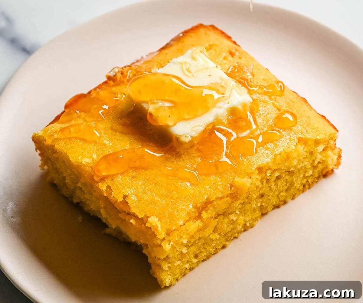 This moist and fluffy hot honey cornbread is sweet, slightly spicy, and absolutely packed with flavor from the very first bite!  This is the most irresistible cornbread topped with hot honey butter you will ever make, and it comes together in just one bowl in under 30 minutes, making it the easiest and most flavorful side dish.