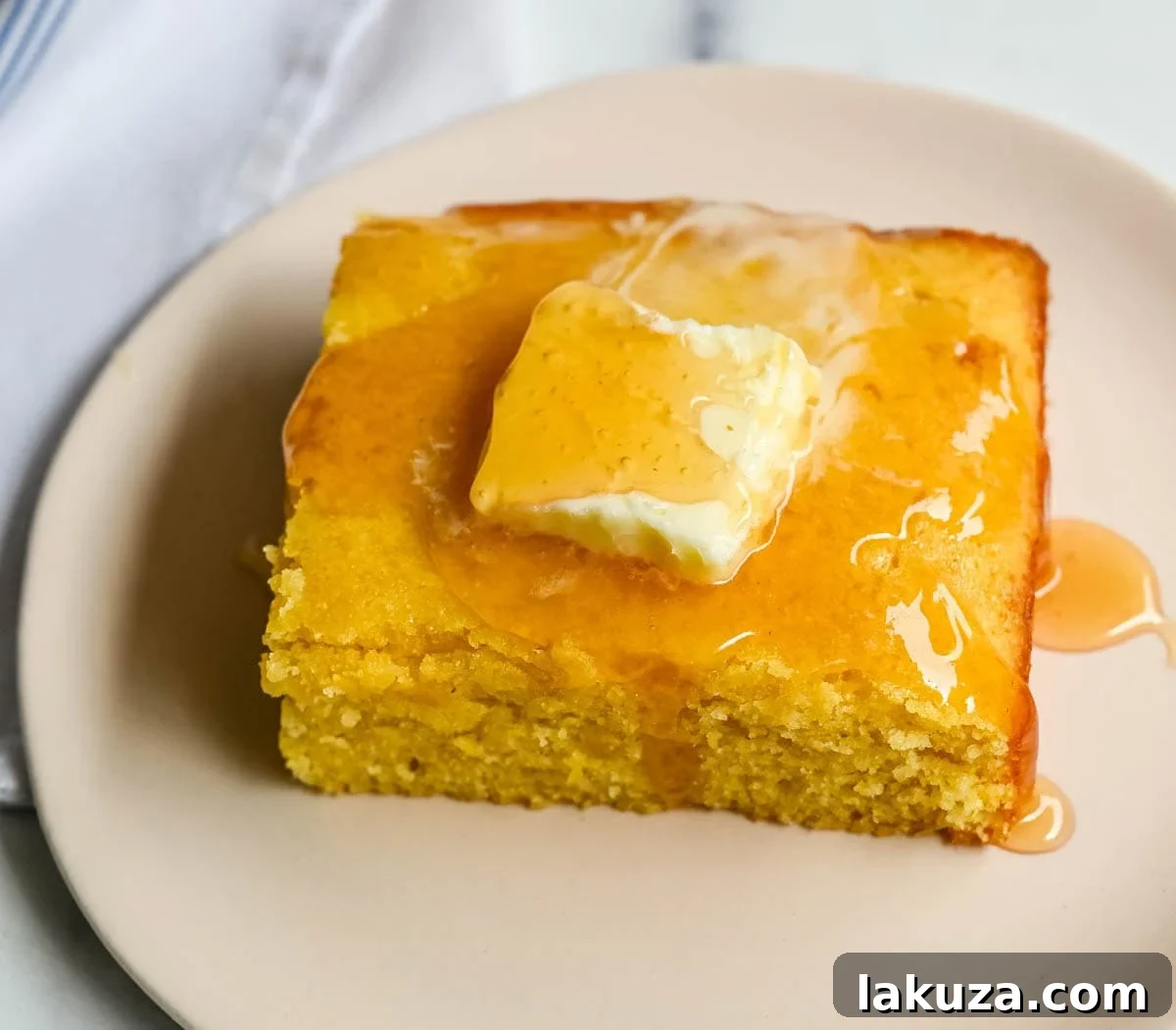 This moist and fluffy hot honey cornbread is sweet, slightly spicy, and absolutely packed with flavor from the very first bite! This is the most irresistible cornbread topped with hot honey butter you will ever make, and it comes together in just one bowl in under 30 minutes, making it the easiest and most flavorful side dish.