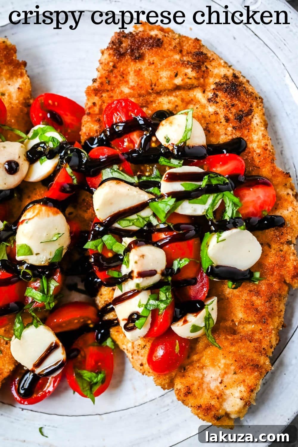 Crispy Caprese Chicken is crispy panko-crusted chicken topped with a fresh grape tomato and mozzarella caprese salad, finished with balsamic glaze. A simple, restaurant-worthy dinner ready in 30 minutes.