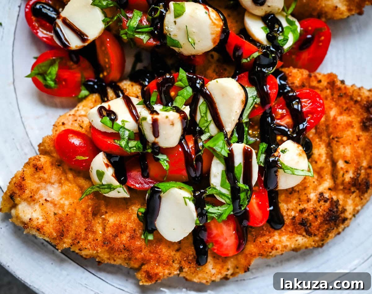 Crispy Caprese Chicken is crispy panko-crusted chicken topped with a fresh grape tomato and mozzarella caprese salad, finished with balsamic glaze. A simple, restaurant-worthy dinner ready in 30 minutes.