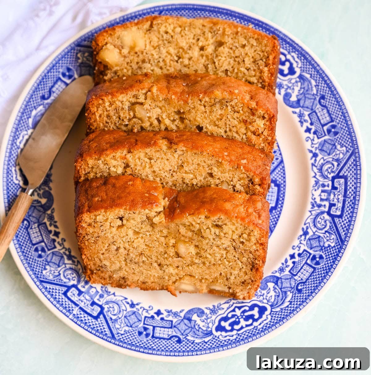 Sliced banana nut bread with nuts visible.
