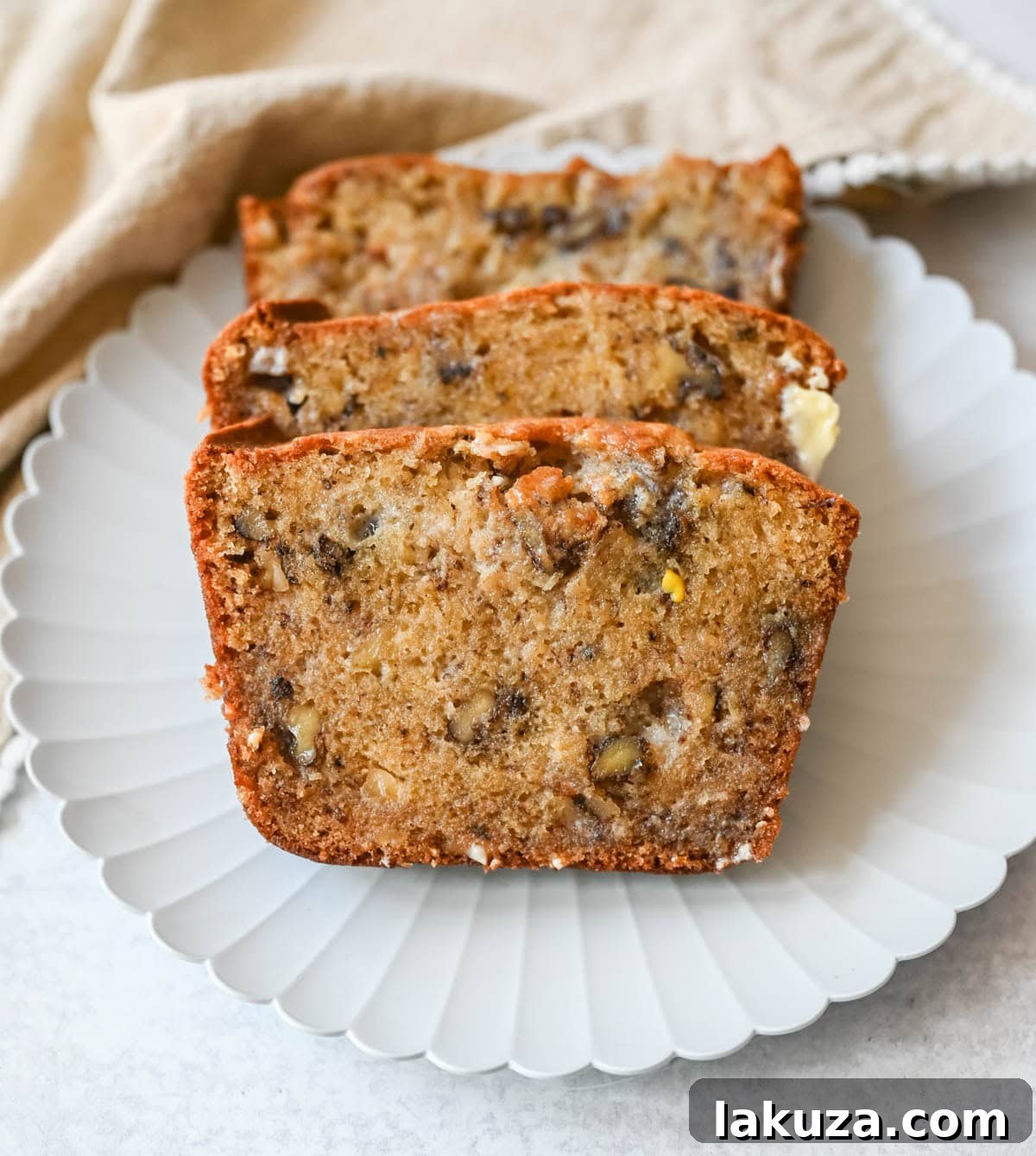 Banana nut bread slice with butter melting.