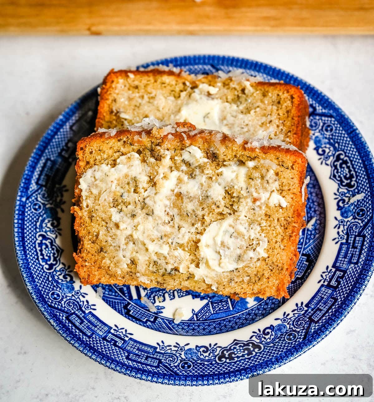 Banana nut bread with nuts and a slice removed.