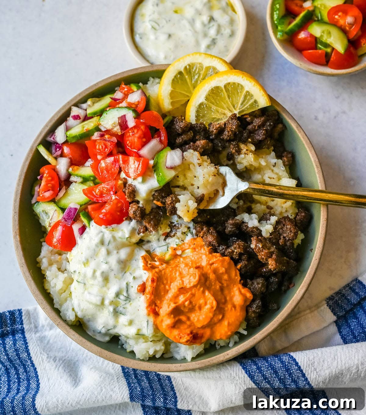 Greek Beef Bowls with Tzatziki, Feta and Lemon Rice 3 Greek Beef Bowls. Juicy seasoned ground beef, bright lemon rice, feta, cucumbers, tomatoes and tzatziki in one easy 35-minute dinner. High-protein bowls that hold up all week for lunches.