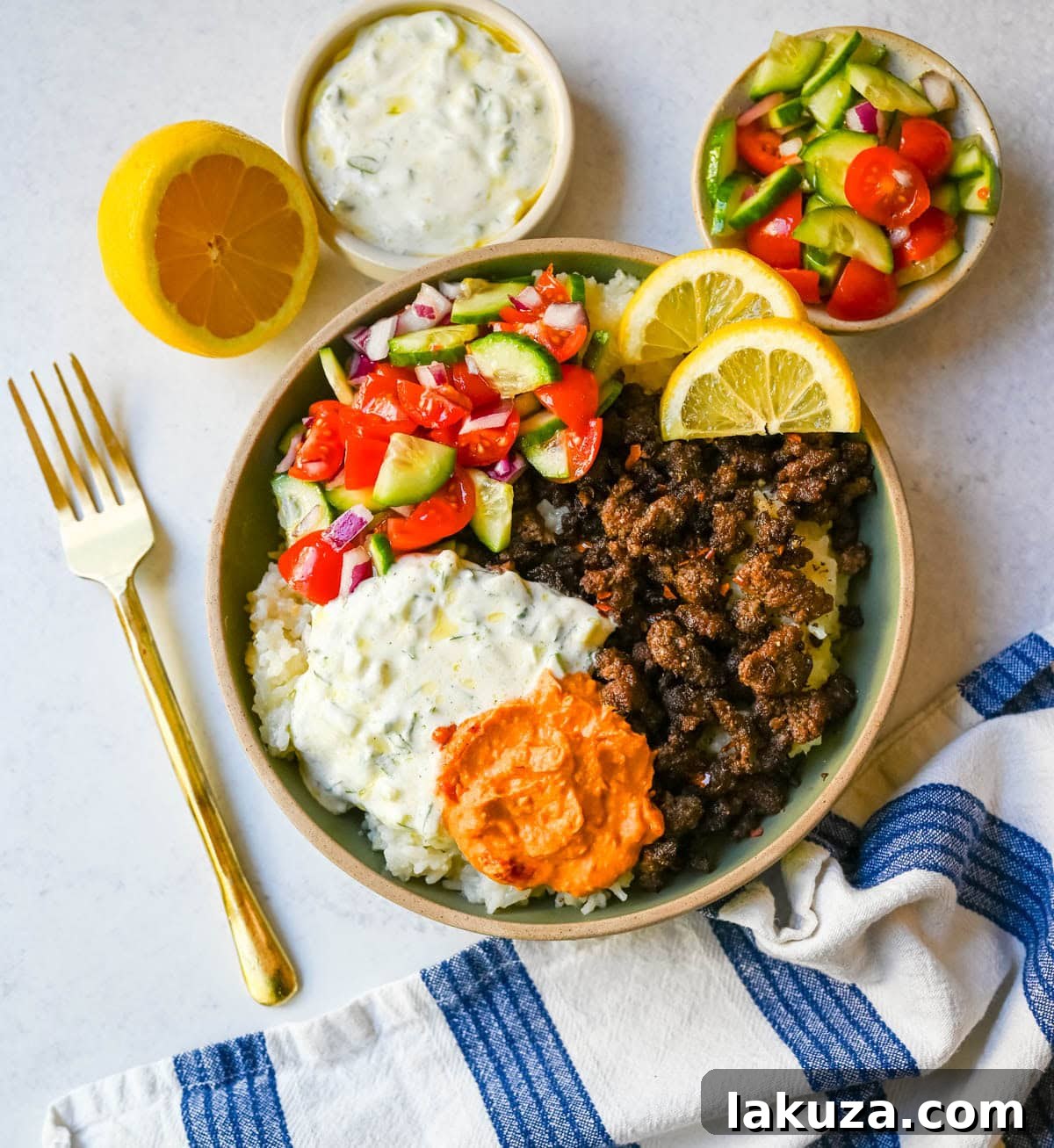 Greek Beef Bowls with Tzatziki, Feta and Lemon Rice 4 Greek Beef Bowls. Juicy seasoned ground beef, bright lemon rice, feta, cucumbers, tomatoes and tzatziki in one easy 35-minute dinner. High-protein bowls that hold up all week for lunches.